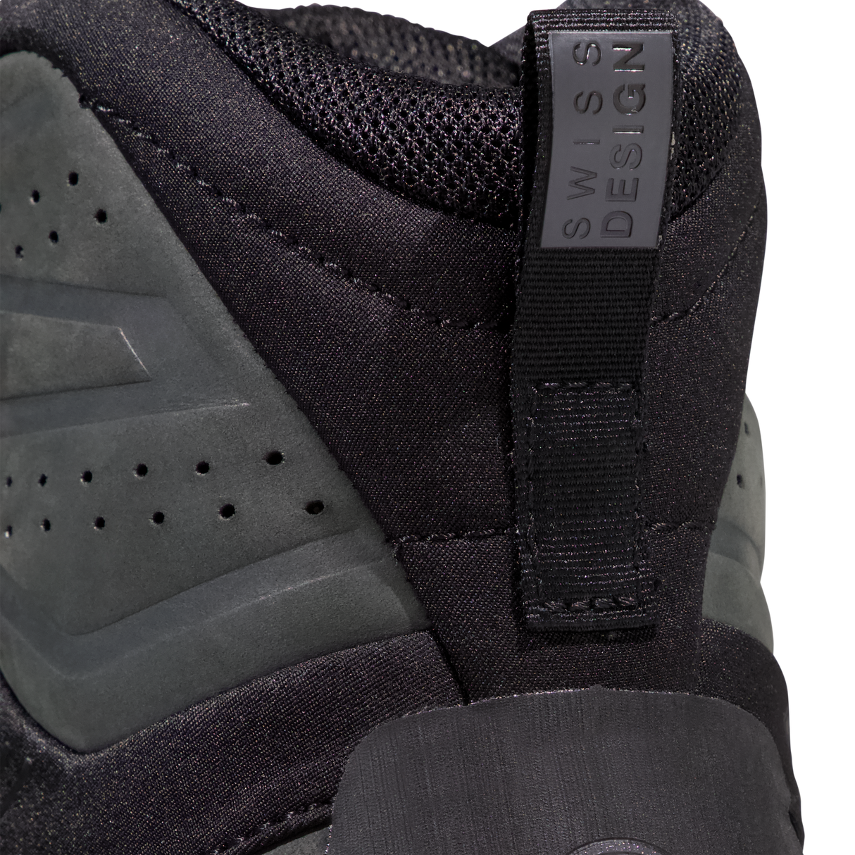 Close-up of the heel area of a black athletic shoe with a pull tab labeled 'SWISS DESIGN' and dark gray suede overlays. - Mammut Mercury Tour II High GORE-TEX (Men's) - Black/Black
