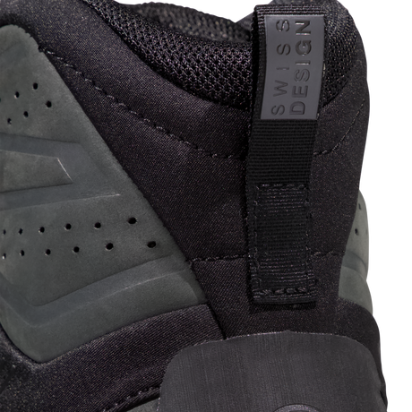 Close-up of the heel area of a black athletic shoe with a pull tab labeled 'SWISS DESIGN' and dark gray suede overlays. - Mammut Mercury Tour II High GORE-TEX (Men's) - Black/Black