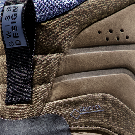 Close-up detail of a brown and gray outdoor boot showing the Swiss Design tab and a Gore-Tex logo on the side. - Mammut Nova Tour II High GORE-TEX Boots (Women's) - Oak/Bark