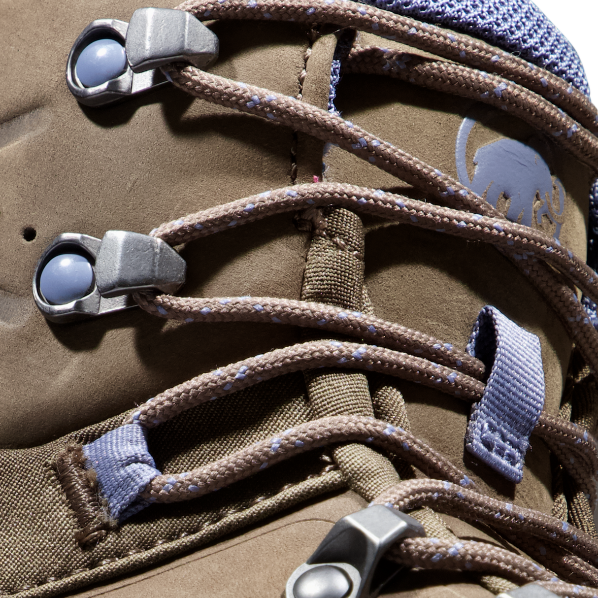 Close-up of a brown suede or nubuck lace-up boot with brown laces threaded through silver metal eyelets and blue webbing loops. A gray Mammut logo is visible on the side. - Mammut Nova Tour II High GORE-TEX Boots (Women's) - Oak/Bark
