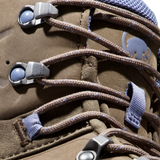 Close-up of a brown suede or nubuck lace-up boot with brown laces threaded through silver metal eyelets and blue webbing loops. A gray Mammut logo is visible on the side. - Mammut Nova Tour II High GORE-TEX Boots (Women's) - Oak/Bark