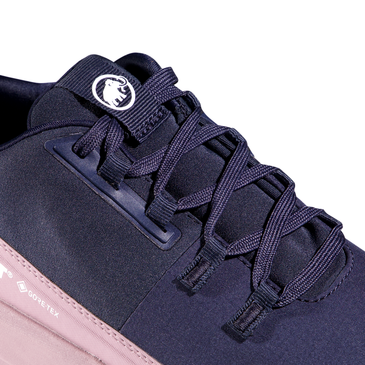 Close-up of a dark navy athletic shoe with matching navy laces, a white circular logo patch on the tongue, and a light pink sole edge on a white background. - Mammut Aenergy Hike Low GORE-TEX Shoes (Women's) - Marine/Dark Alpine Calamint