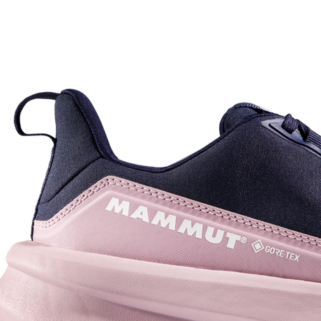 Close-up of a Mammut sneaker showing the heel and side profile, featuring a dark navy blue upper, a light pink midsole section with white Mammut and GORE-TEX branding, and a pale pink sole on a white background. - Mammut Aenergy Hike Low GORE-TEX Shoes (Women's) - Marine/Dark Alpine Calamint