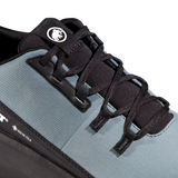Close-up of a trail running shoe showing the side profile, featuring a slate blue-gray upper, black laces, black plastic lace guard, and a black heel section with a visible GORE-TEX logo. - Mammut Aenergy Hike Low GORE-TEX (Men's) - Strata/Black