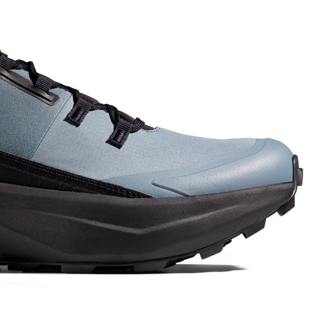 Close-up of a trail running shoe showing the side profile, featuring a light blue textured upper, black laces, and a thick black midsole and outsole on a white background. - Mammut Aenergy Hike Low GORE-TEX (Men's) - Strata/Black