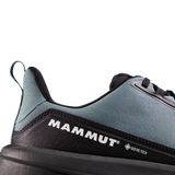 Close-up of the heel and side of a Mammut shoe in slate blue and black, showing the Mammut logo and a small Gore-Tex mark on a clean white background. - Mammut Aenergy Hike Low GORE-TEX (Men's) - Strata/Black
