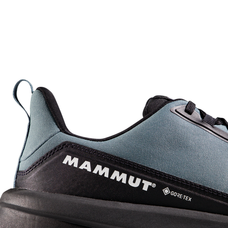 Close-up of the heel and side of a Mammut shoe in slate blue and black, showing the Mammut logo and a small Gore-Tex mark on a clean white background. - Mammut Aenergy Hike Low GORE-TEX (Men's) - Strata/Black
