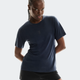 Person wearing a navy blue athletic shirt and black shorts on a light gray background - On Trail-T (Women's) - Navy