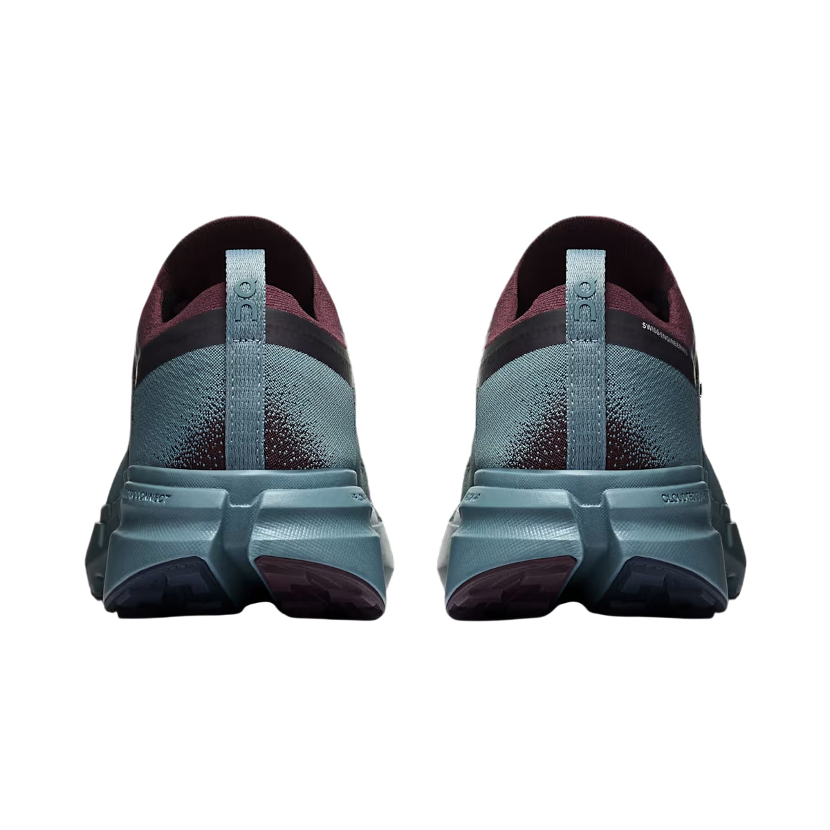 A pair of running shoes shown from the back, featuring a textured slate blue-green upper with dark burgundy accents and a thick matching midsole. - On Cloudsoma Shoes (Men's) - Urchin/Agave