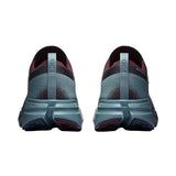 A pair of running shoes shown from the back, featuring a textured slate blue-green upper with dark burgundy accents and a thick matching midsole. - On Cloudsoma Shoes (Men's) - Urchin/Agave