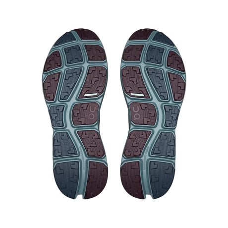 The outsoles of a pair of running shoes, showing a multi-colored geometric tread pattern in shades of dark teal, slate blue, and deep burgundy. The brand 'UON' is embossed on several sections of the sole. - On Cloudsoma Shoes (Men's) - Urchin/Agave
