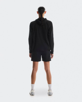 Person wearing a black hoodie and shorts on a white background - On Performance Jacket (Women's) - Black