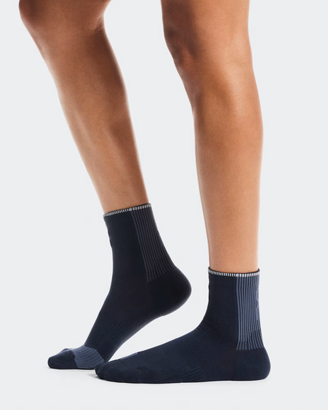 Navy socks worn by a person on a light gray background - On Performance Run Sock Mid (Unisex) - Navy/Navy