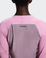 Person wearing a pink and gray long-sleeve shirt with a white background - On Performance Long-T (Women's) - Dewberry/Sakura