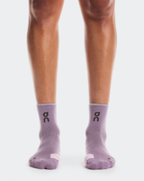 Purple socks with a logo worn by a person on a white background - On Performance Run Sock Mid (Unisex) - Dewberry/Sakura
