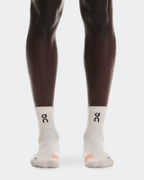 White socks with a logo worn by a person on a white background - On Performance Run Sock Mid (Unisex) - Pearl/Sunstone