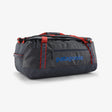 Gray duffel bag with red accents and Patagonia logo on a white background - Patagonia Black Hole Duffel 55L - Smolder Blue w/Amanita Red