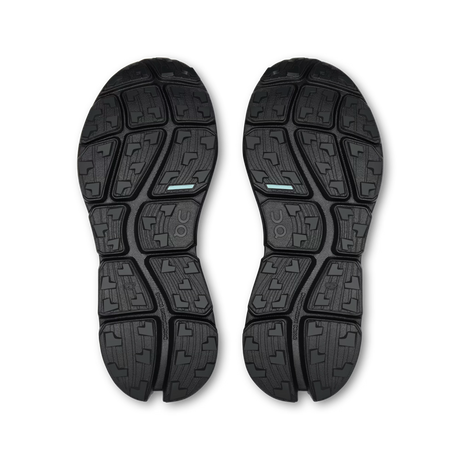 A pair of black athletic shoe soles shown from a top-down view on a white background, featuring a segmented tread pattern with a small light blue accent stripe. - On Cloudsoma Shoes (Women's) - Black/black