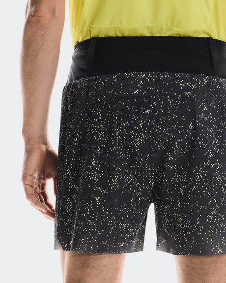 Black shorts with white speckle pattern worn by a person, on a light gray background - On Ultra Shorts (Men's) - Iron/Lime