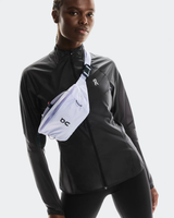 Person wearing a black jacket with a white fanny pack on a light gray background - On Waist Pack 2L Lite - Thistle