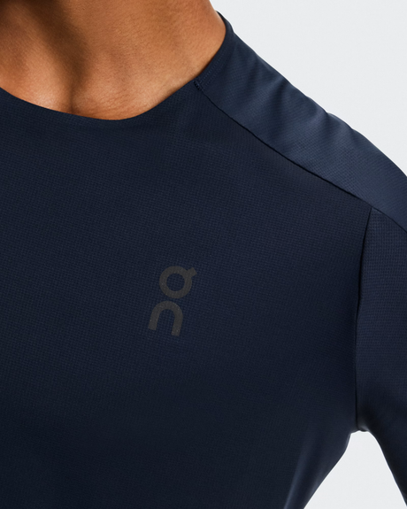 Navy blue athletic shirt with a logo on a light gray background - On Performance-T (Men's) - Navy/Black