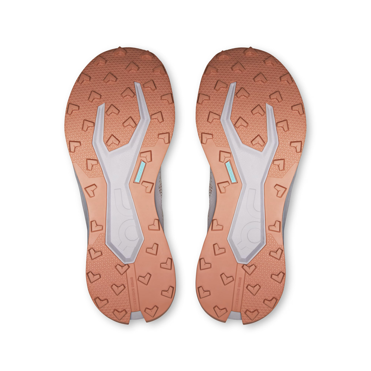 Top-down view of a pair of athletic shoes showing the textured outsoles in a warm copper-orange color with a light gray central tread and small mint-blue accent details. - On Cloudultra 3 Shoes (Women's) - Oyster/Ether