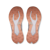 Top-down view of a pair of athletic shoes showing the textured outsoles in a warm copper-orange color with a light gray central tread and small mint-blue accent details. - On Cloudultra 3 Shoes (Women's) - Oyster/Ether