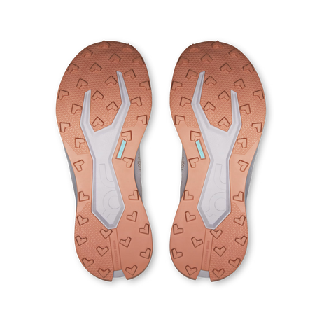 Top-down view of a pair of athletic shoes showing the textured outsoles in a warm copper-orange color with a light gray central tread and small mint-blue accent details. - On Cloudultra 3 Shoes (Women's) - Oyster/Ether