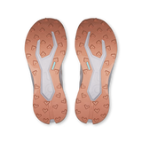 Top-down view of a pair of athletic shoes showing the textured outsoles in a warm copper-orange color with a light gray central tread and small mint-green accents. - On Cloudultra 3 Shoes (Women's) - Oyster/Ether