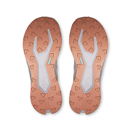Top-down view of a pair of athletic shoes showing the textured outsoles in a warm copper-orange color with a light gray central tread and small mint-green accents. - On Cloudultra 3 Shoes (Women's) - Oyster/Ether