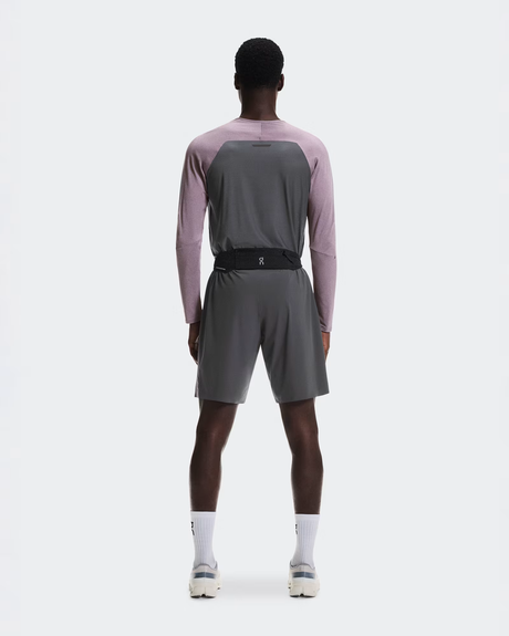 Person wearing a gray athletic outfit with a pink long-sleeve shirt on a white background - On Speed Belt (Unisex) - Black