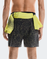 Person wearing black shorts with yellow speckles and a yellow shirt over the shorts on a white  - On Ultra Shorts (Men's) - Iron/Limebackground