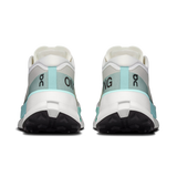 A pair of running shoes shown from the back, featuring a white and light gray upper with mint green accents and black outsoles. The brand logo 'on' is visible on the heel area. - On Cloudultra Pro Shoes (Women's) - Ivory/Celeste