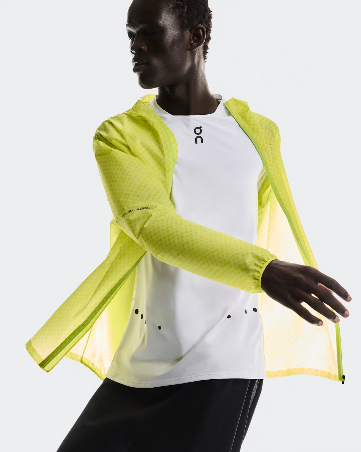 Person wearing a bright yellow jacket over a white shirt on a light gray background - On Ultra Jacket (Men's) - Limelight/Lime