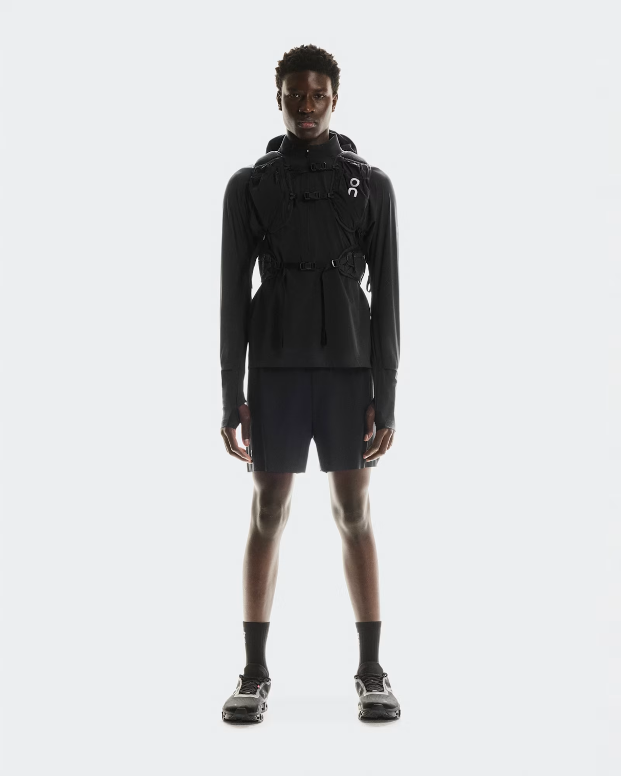Person wearing a black outfit with a hood on a white background - On Trail Pack 20L - Black