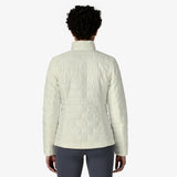 Person wearing a light-colored quilted jacket on a white background - Patagonia Nano Puff Jacket (Women's) - Birch White