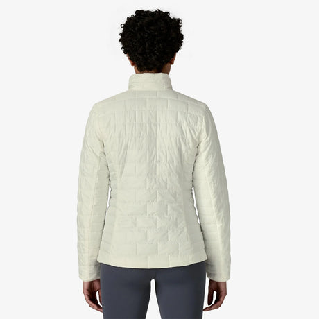 Person wearing a light-colored quilted jacket on a white background - Patagonia Nano Puff Jacket (Women's) - Birch White