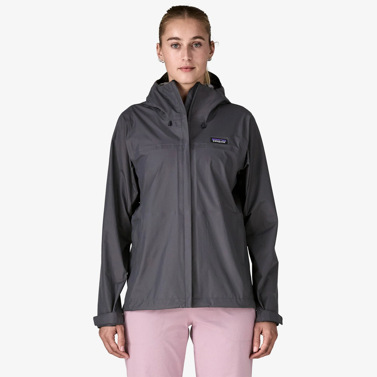 Person wearing a gray rain jacket with a visible brand logo on a white background - Patagonia Torrentshell 3L Rain Jacket (Women's) - Smolder Blue