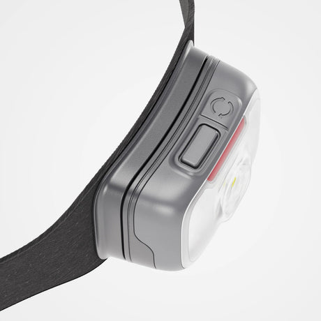Close-up of a headlamp with a gray casing and black strap on a light gray background - Biolite Range 500 Headlamp - Midnight Grey