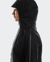 Person wearing a black hooded jacket on a white background - On Performance Jacket (Women's) - Black