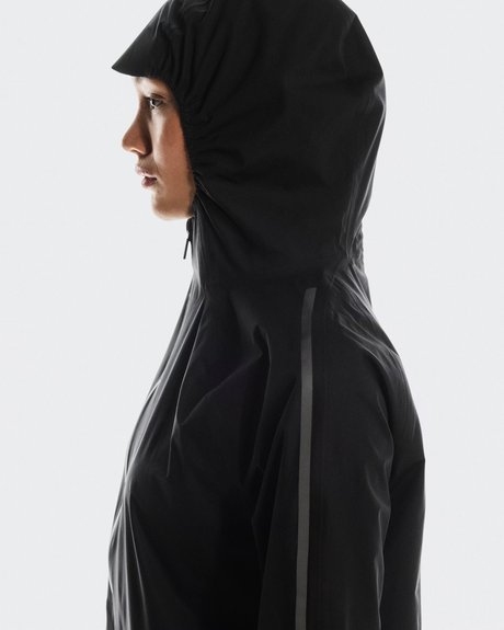 Person wearing a black hooded jacket on a white background - On Performance Jacket (Women's) - Black