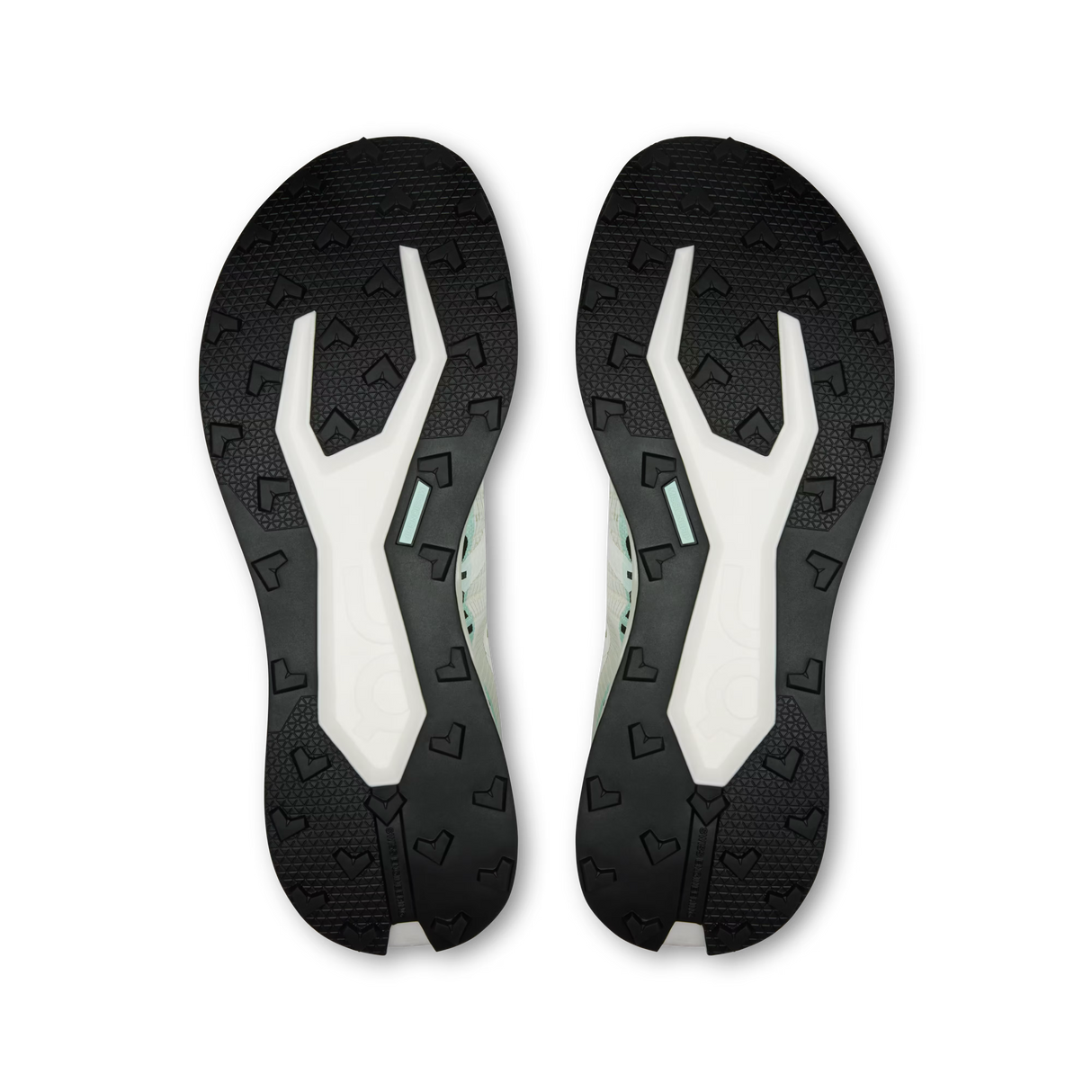 A pair of athletic shoe soles shown from the bottom, featuring a black textured outsole with a white and mint green Y-shaped midsole design, photographed on a solid white background. - On Cloudultra Pro Shoes (Men's) - Ivory/Celeste