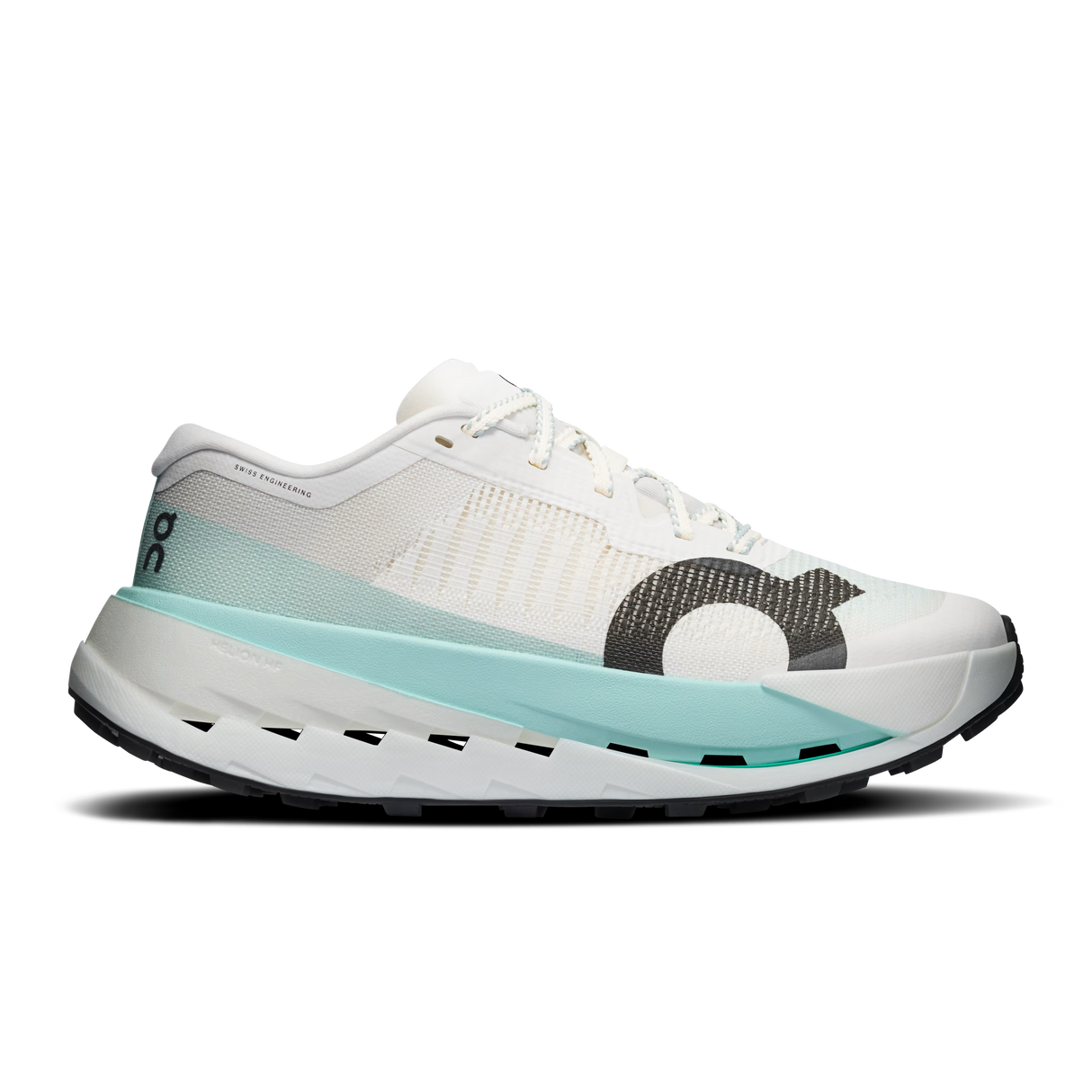 A white On running shoe with a light blue midsole accent and a dark gray textured circular logo on the side, shown against a plain white background. - On Cloudultra Pro Shoes (Women's) - Ivory/Celeste
