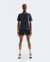 Person wearing a dark blue t-shirt, black shorts, and white socks on a white background - On Trail-T (Women's) - Navy
