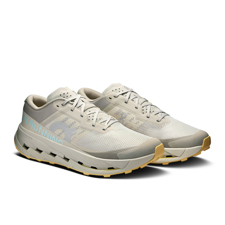 A pair of light gray and off-white running shoes with a light blue 'RUNNING' text detail on the side and a tan outsole, shown against a plain white background. - On Cloudultra 3 Shoes (Men's) - Brume/Winter