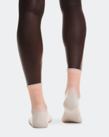 Person wearing dark tights and light-colored socks on a white background - On Performance Run Sock Mid (Unisex) - Pearl/Sunstone