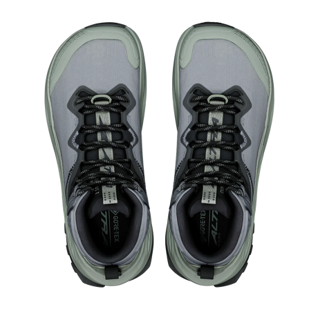A pair of Gore-Tex All Weather hiking shoes shown from a top-down view, featuring a gray and sage green upper with black laces and a light gray sole. - Altra Olympus 7 Hike Mid GORE-TEX Boots (Women's) - Castlerock