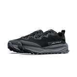 A pair of black and dark gray trail running shoes with a thick cushioned sole, shown from a side profile view on a white background. - Altra Olympus 7 Shoes (Women's) - Black/Silver/Castlerock
