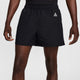 Black athletic shorts with an elastic waistband, side pockets, and a small white geometric logo on the left hip, shown on a model against a light gray background. - Nike ACG Reservoir Goat Shorts (Men's) - Black/Anthracite/Summit White