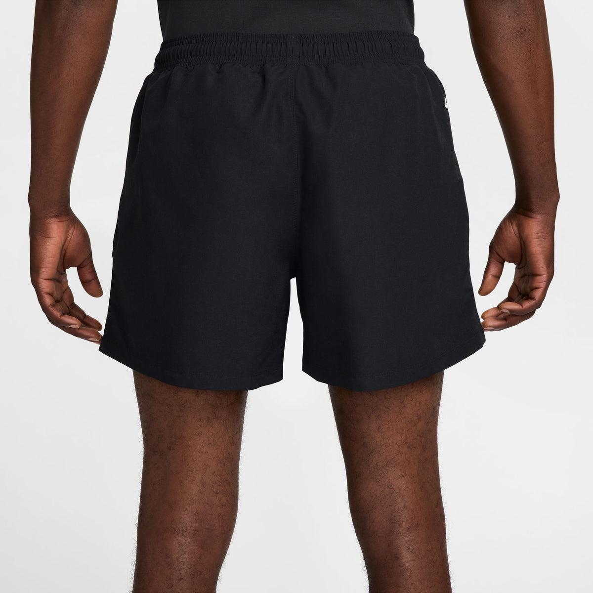 Rear view of a person wearing black athletic shorts against a light gray studio background. - Nike ACG Reservoir Goat Shorts (Men's) - Black/Anthracite/Summit White